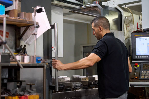 istock Metalworker operating cnc machine in manufacturing plant 2182522147