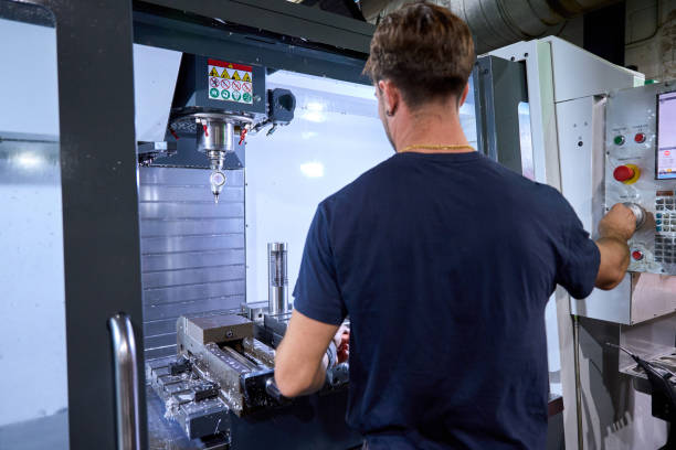 istock Metalworker operating cnc machine for custom mechanical parts manufacturing 2182522283