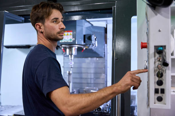istock Metalworker operating cnc machine in modern factory 2182522313