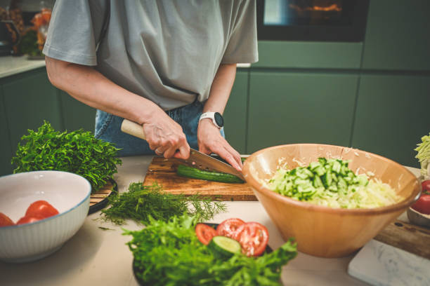 istock woman preparing salad in the kitchen 2182534831