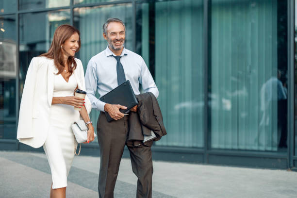 istock Smiling Business Professionals Walking Outside Office Building 2182538838