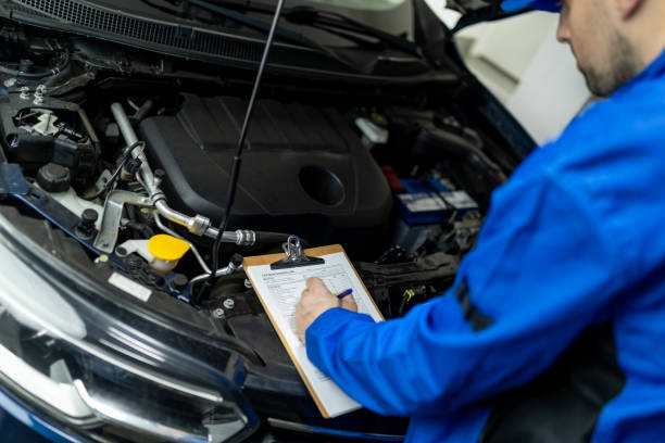 istock Automotive technician inspecting engine components during a maintenance check in a repair shop on a busy weekday afternoon 2182541161
