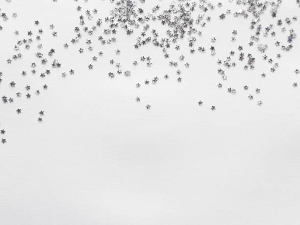 istock Scattered silver star confetti on minimalist white background 2182548657