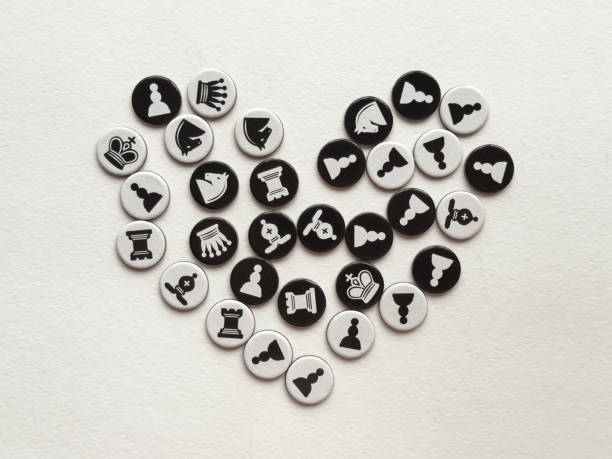 Chess themed heart shape with black and white game pieces on white background
