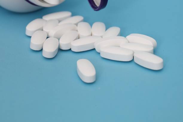 istock white tablets and a blister with blue capsules 2182549111
