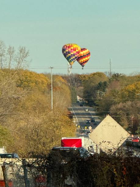 istock Hot air balloon flying along a highway in Michigan. 2182549849