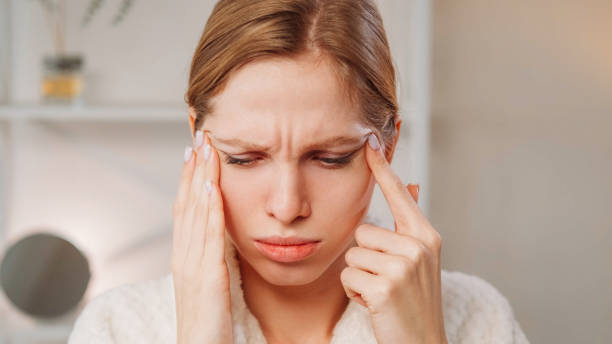 istock Headache woman stress result touching head temples 2182551311