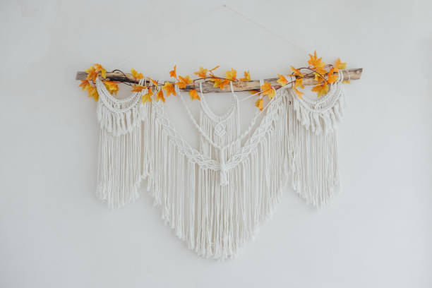 istock Macrame wall hanging adorned with autumn leaves in a minimalist interior setting 2182551583