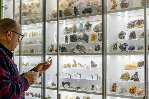 istock Geologist sips coffee while looking at his mineral collection 2182552576