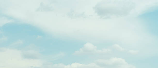 istock Blue sky with clouds and white background with green tint 2182553418