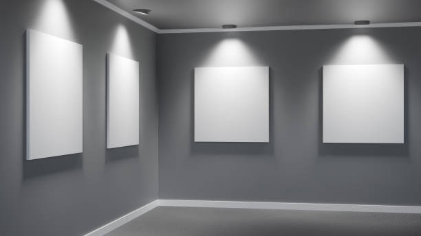 istock Corner wall in minimalist art gallery with four large illuminated blank canvases 2182553615