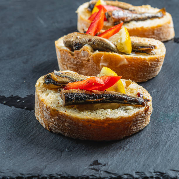 istock three fish sandwiches on a stone board on the table 2182557460