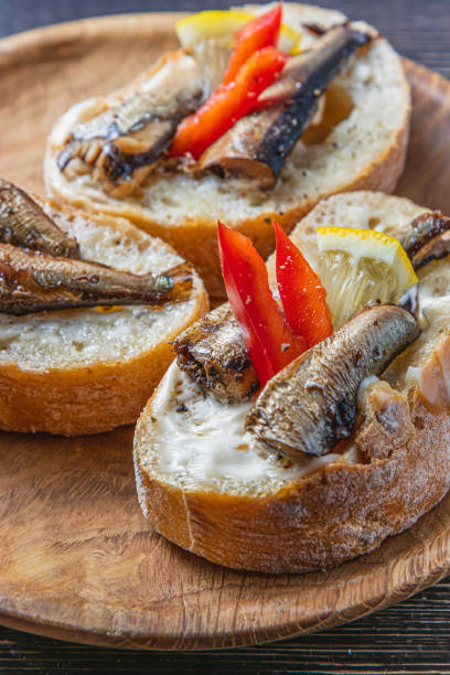 istock fish sandwich with butter and sprats lemon and red pepper 2182557952