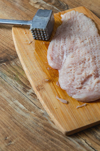 hammering fillet for chop on kitchen table High quality photo