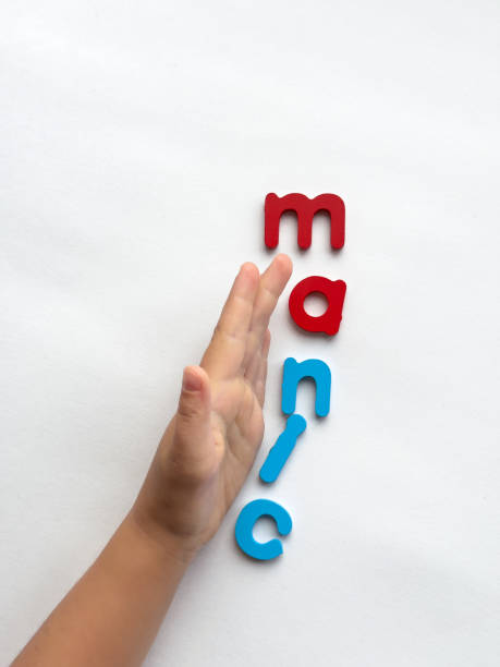 istock Childs hand with colorful manic letters on white background 2182566626