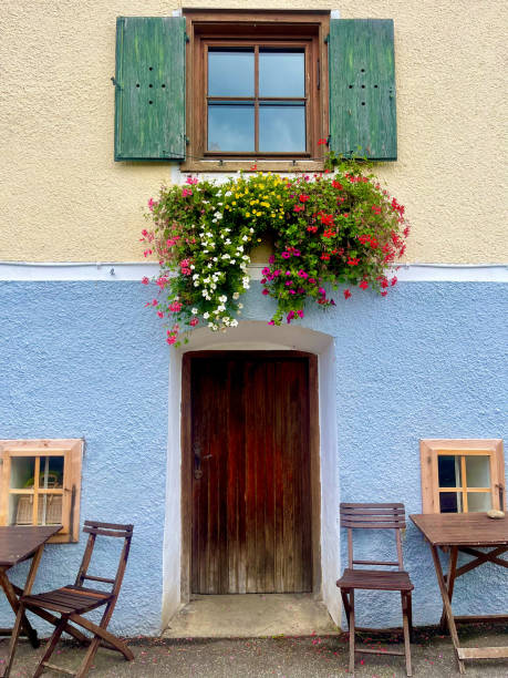 istock Austrian house doorway with window box and green shutters 2182568430