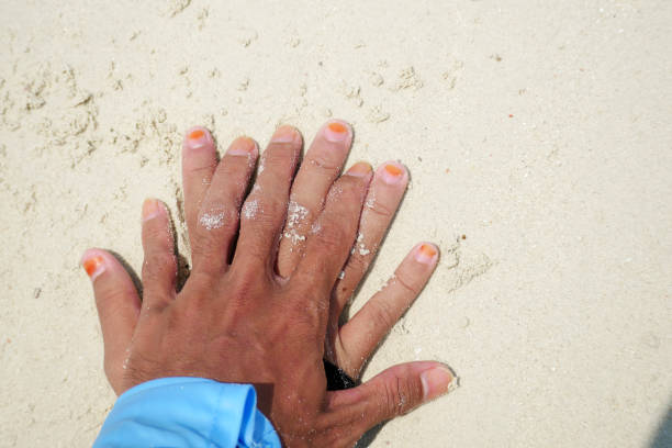 two couple hands on the beach sand