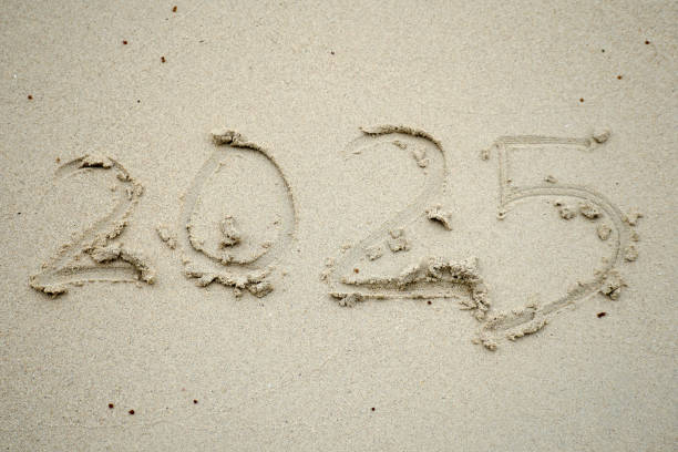 istock 2025 year number text on beach sand 2182572440