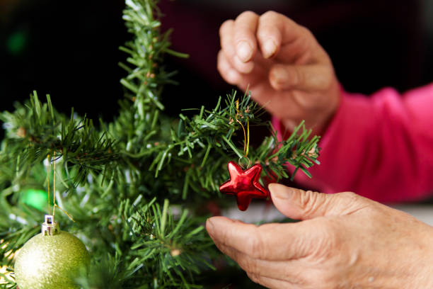 istock A person is decorating a Christmas tree with a red star 2182578142