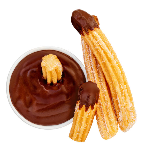 Churros isolated. Fried Churro with melting chocolate dip sauce in bowl on white. Churros pastry top view. Flat lay