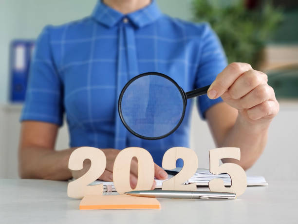 istock Analyzing future trends for 2025 with a magnifying glass 2182585389