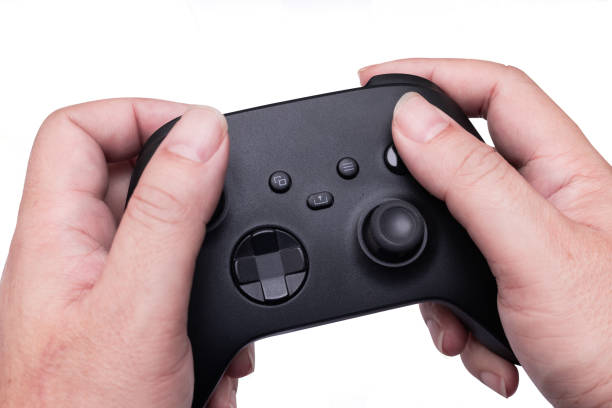 istock Hands holding black gaming controllers isolated on white background. Gamer object 2182589646