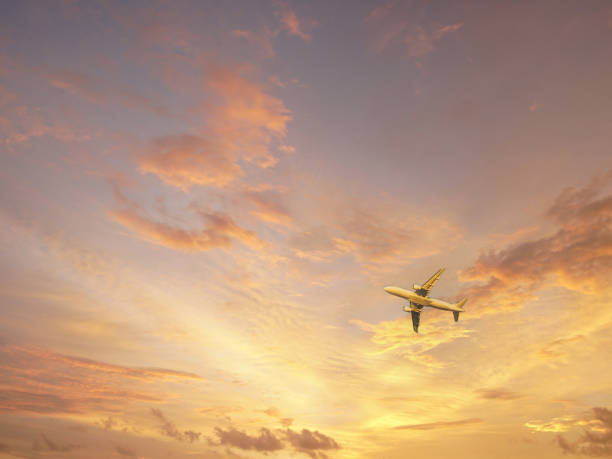 istock Commercial airplane flying over a red sky at sunset 2182591433