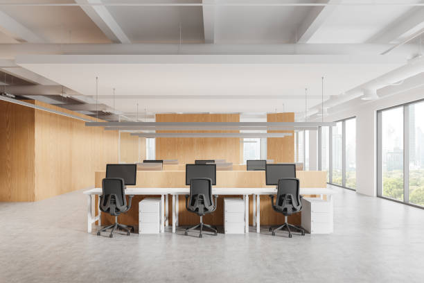 istock Office coworking interior with pc monitors in row, panoramic window 2182597582