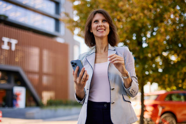 istock Confident Businesswoman Using Smartphone in Urban Setting 2182599322