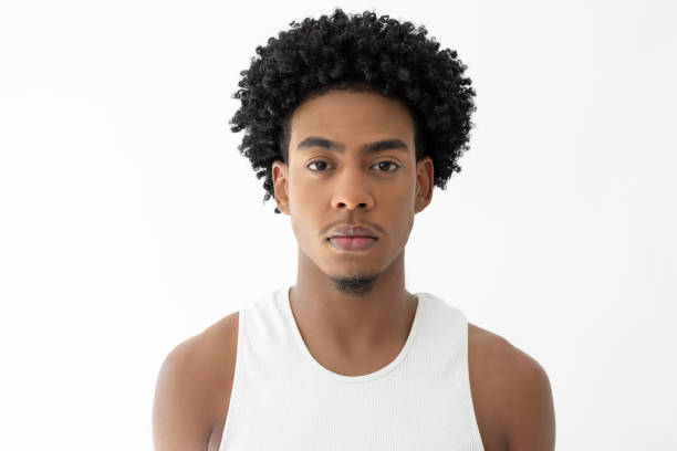 Portrait of black young man with afro hair on white background