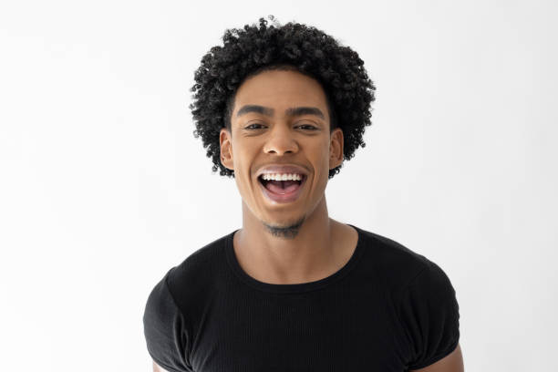 Happy young man laughing with positive emotion