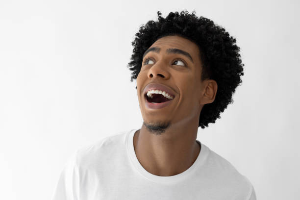 istock Happy afro haired male looking up 2182602863