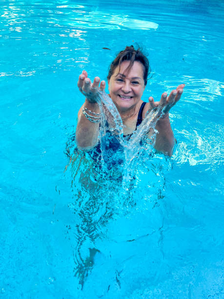 istock Attractive Hispanic senior woman in pool 2182606148