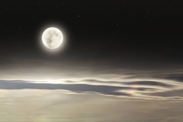 Bright full moon with soft elongated clouds and stars at night. Photo combination