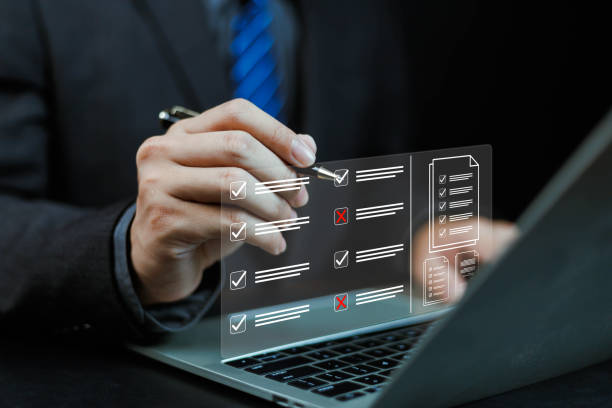 istock Businessman working on computer using laptop. Concept of business performance tracking and evaluation. Document management system DMS. Performance checklist evaluation form. 2182608367