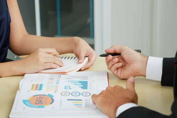 istock Closed up Asian Business people hands is writing on paperwork and brainstorming for project job with  information on wooden table in meeting room at office 2182611430