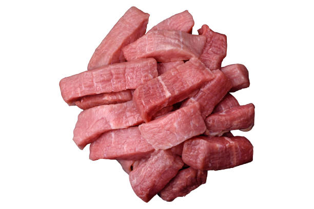 Juicy beef cut into slices with salt, spices and herbs on a white background