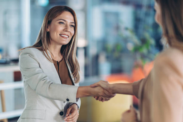 istock Businesswomen shaking hands in the office 2182613861