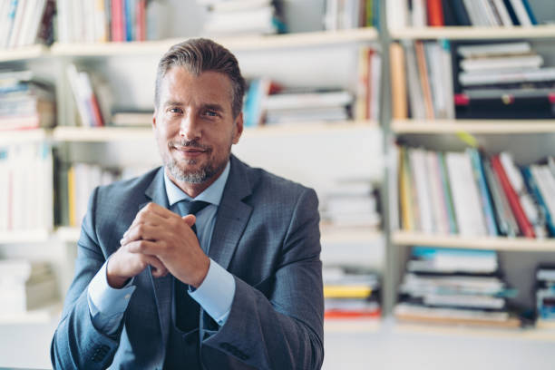istock Middle age businessman with library at the background 2182613866