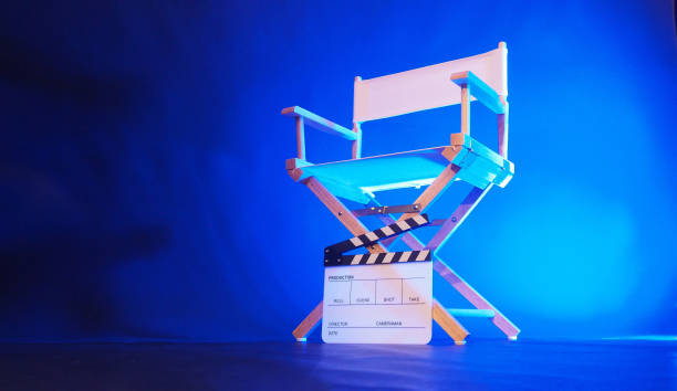 istock Director chair and clapper board in blue light. 2182613902