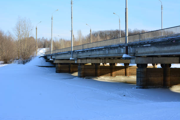 a frozen river with the bridge across it close up