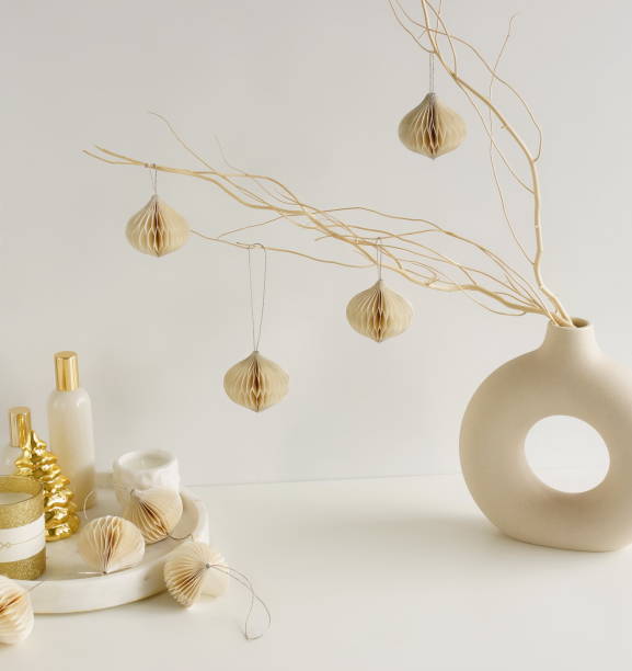 istock Christmas decor on white table  background. Paper ornaments on a  branches in a beige vase. 2182615376
