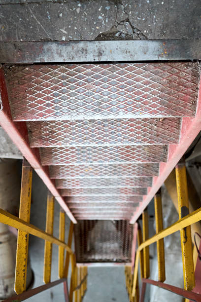 istock Example of chemical plant steampunk retro style interior part with copyspace. Abstract image of industrial textured rusted stairs going down vertical or downstairs. 2182618797