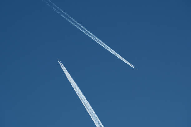 Airplane trails in the blue sky, contrails.