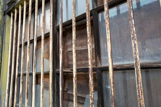 istock Old iron grates and broken glass windows. 2182620638