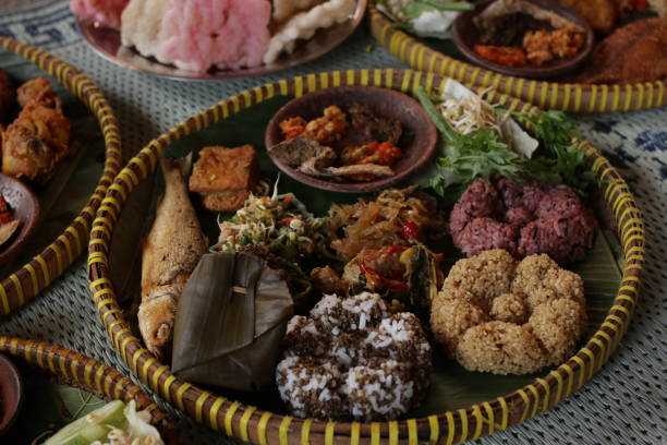 istock Tiwul rice and various traditional Javanese snacks presented on a bamboo circular tray. 2182620668