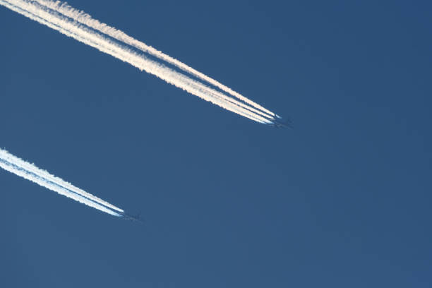 Airplane trails in the blue sky, contrails.