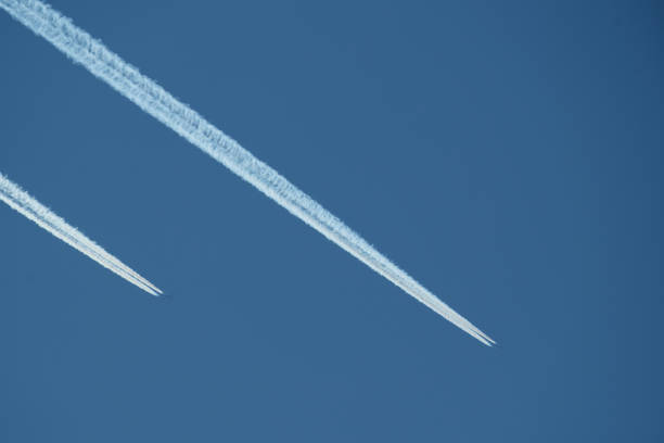 Airplane trails in the blue sky, contrails.