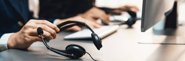 istock Panorama focus headset on call center workspace desk with blur operator. Prodigy 2182620840
