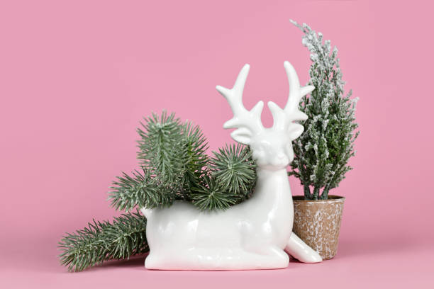 istock Christmas or winter decoration deer figurine with fir branches and small tree 2182620868